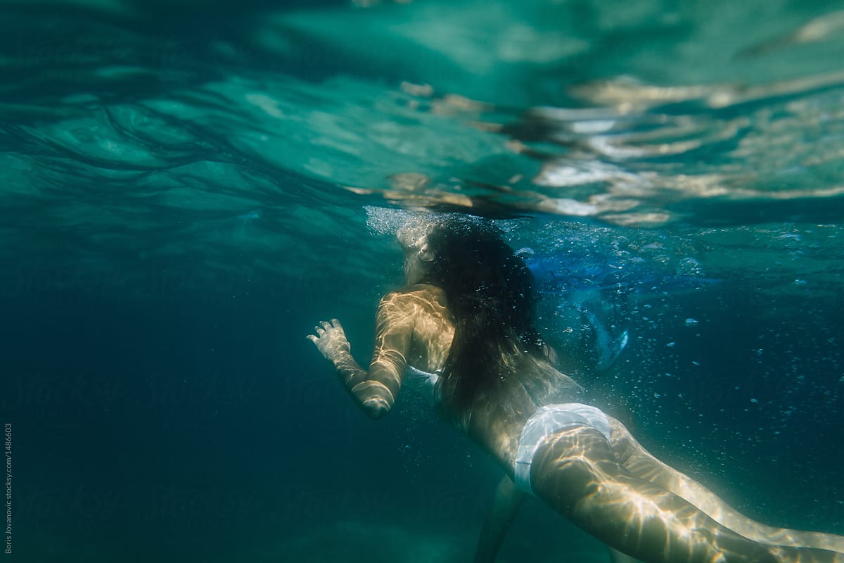 Woman Diving Into The Deep Blue Sea