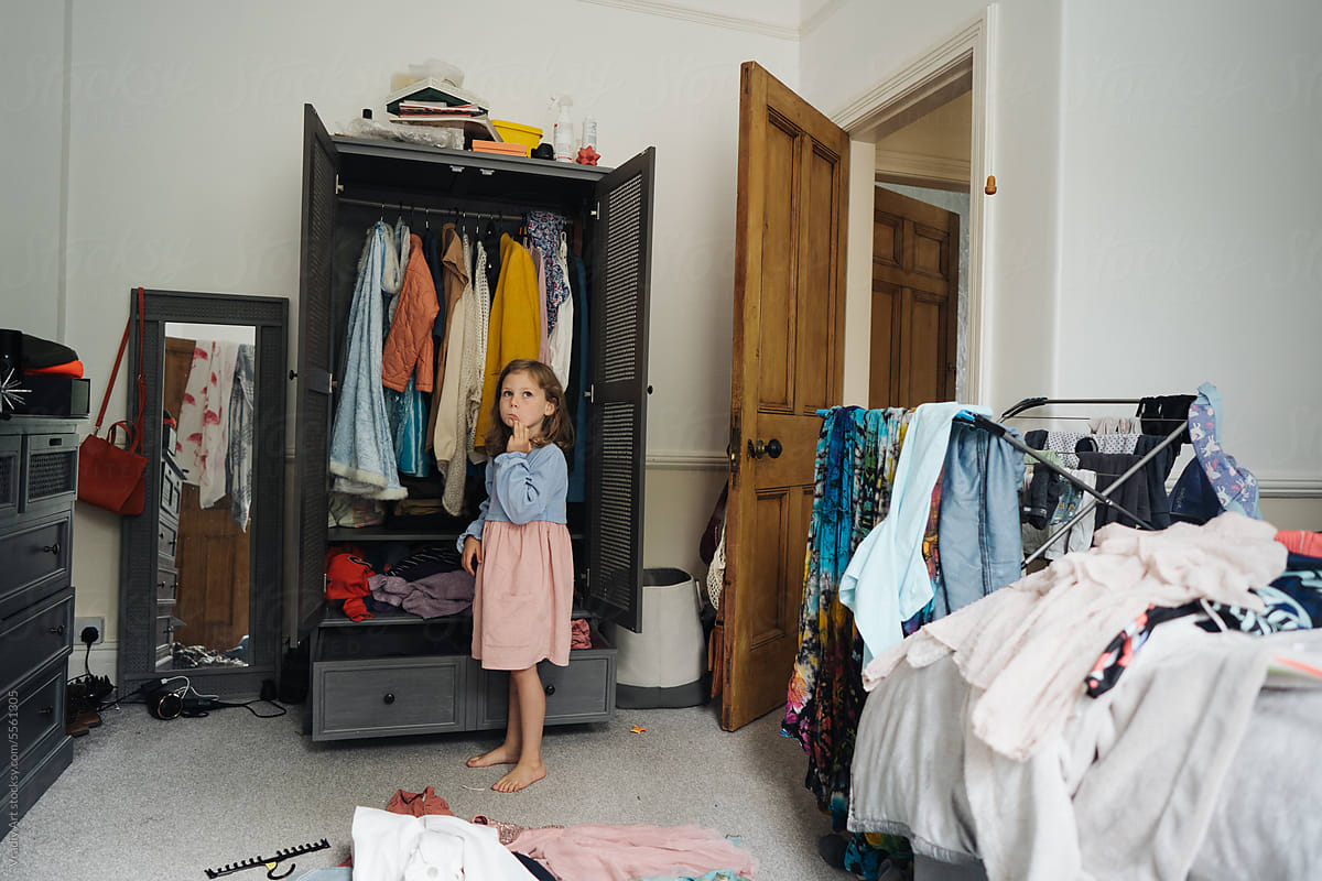 Kid in the wardrobe room