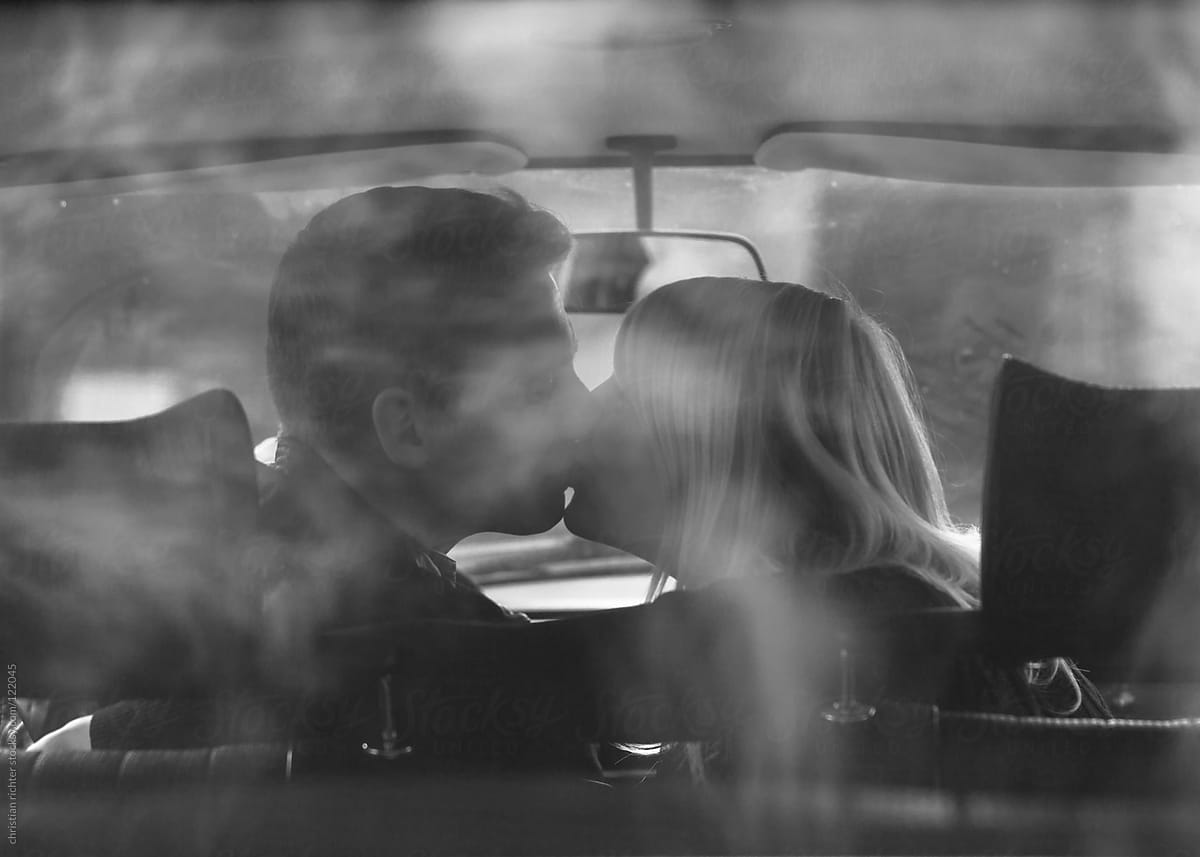 couple kissing in old vintage car