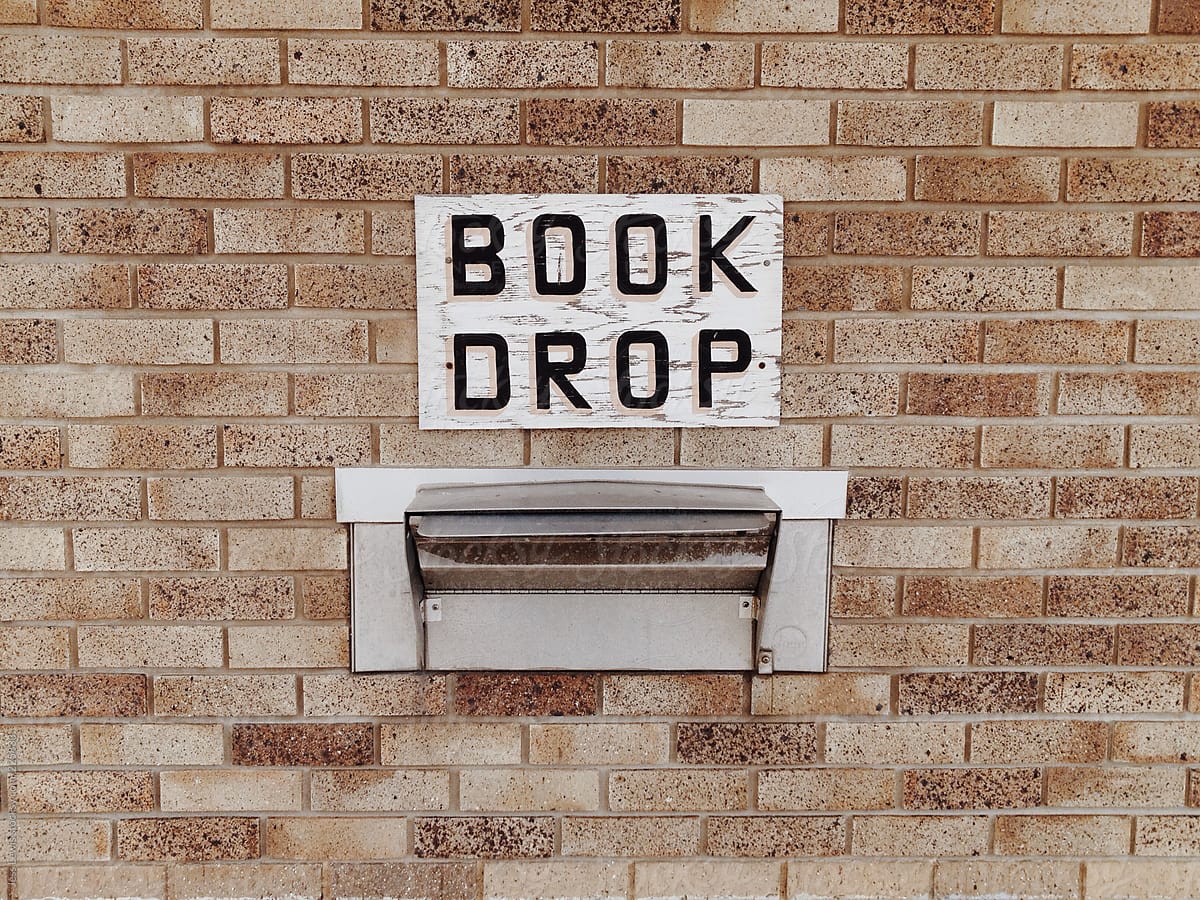 library book drop off sign on building
