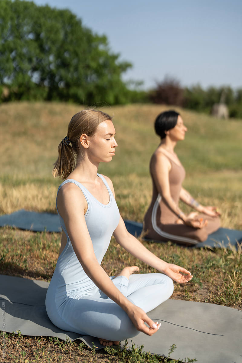Young females sitting at lotus pose and relaxing