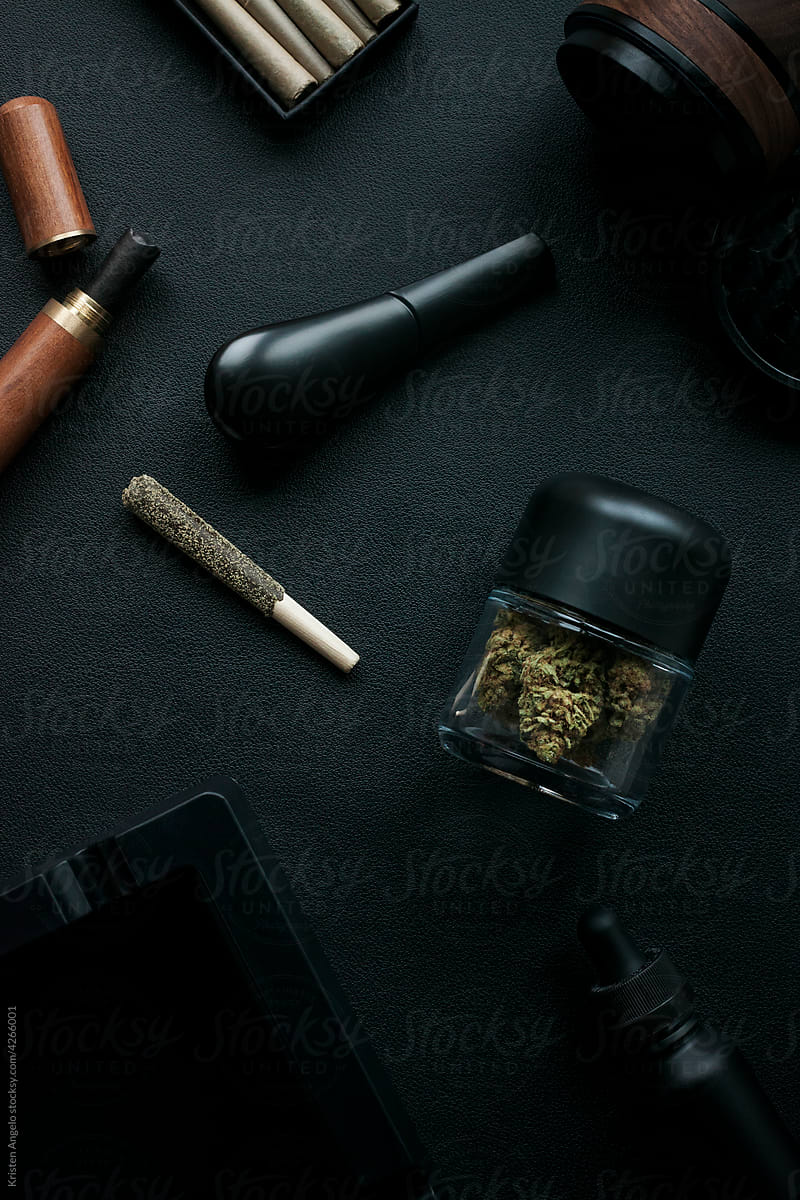 Flatlay of assorted luxury cannabis accessories and products