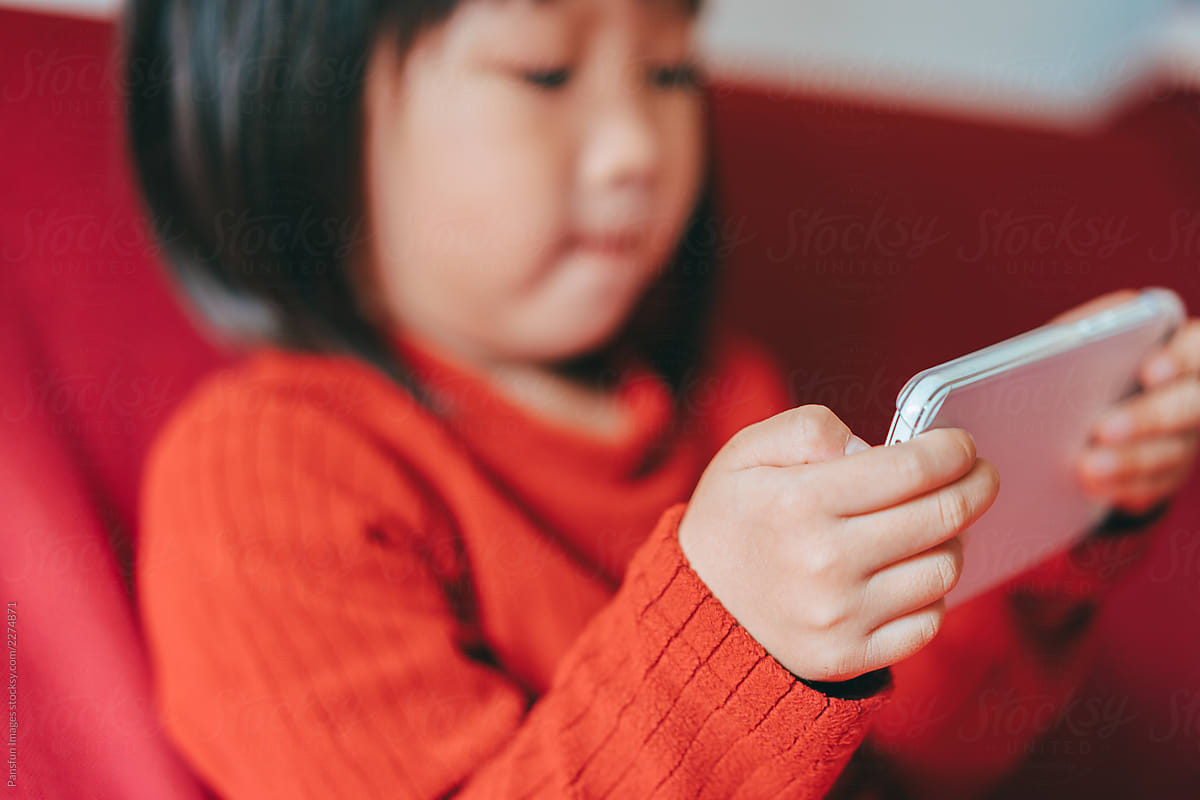 Asian Baby Girl Watching Video Via Cell Phone by Pansfun Images -  Cellphone, Kid