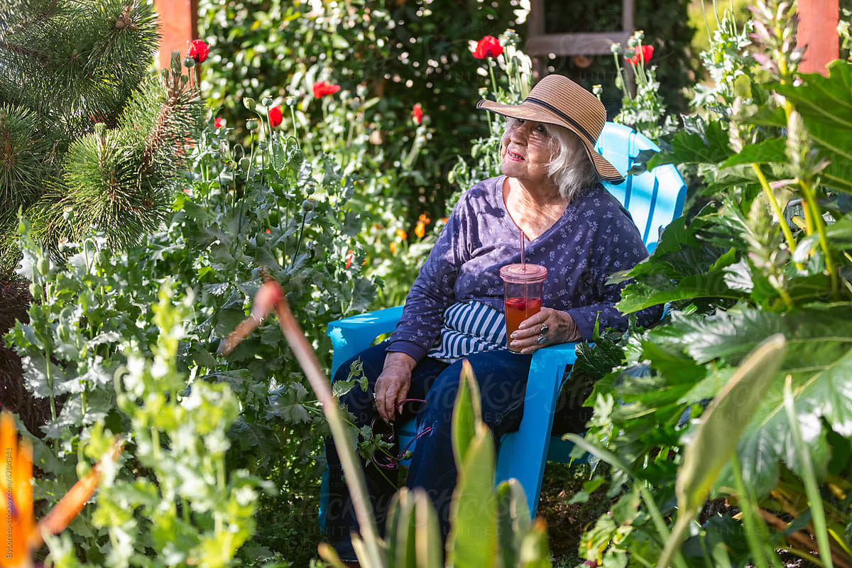 Senior woman sitting in tropical garden middle