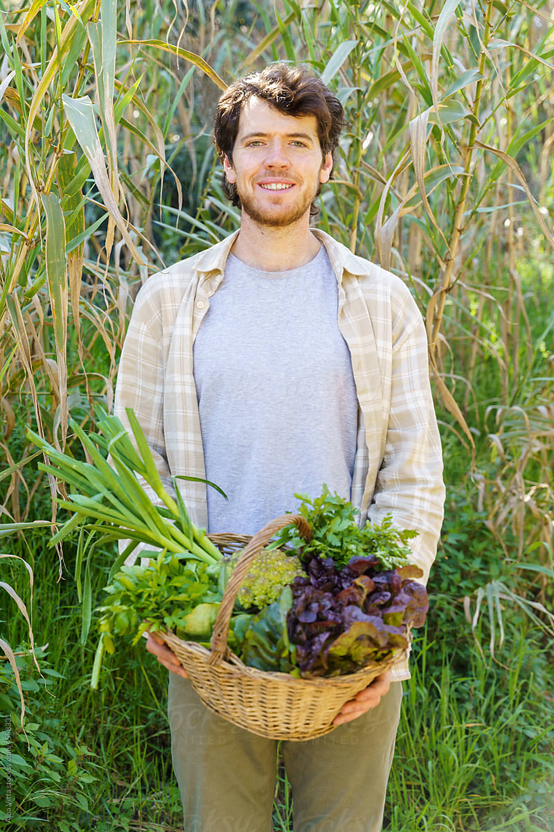 Man holding veggies basket from the garden