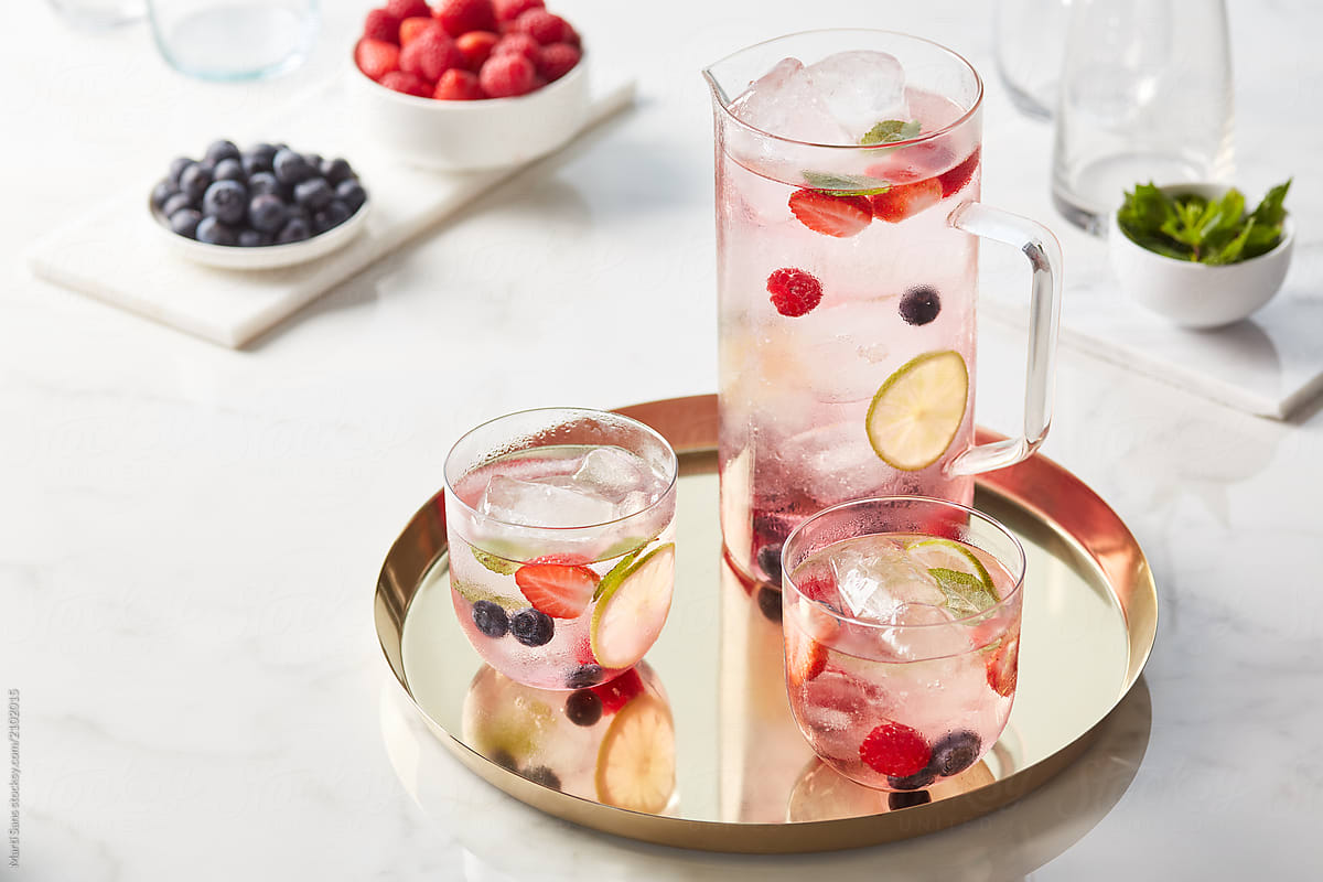 Jar and two glasses of delicious fruit water.