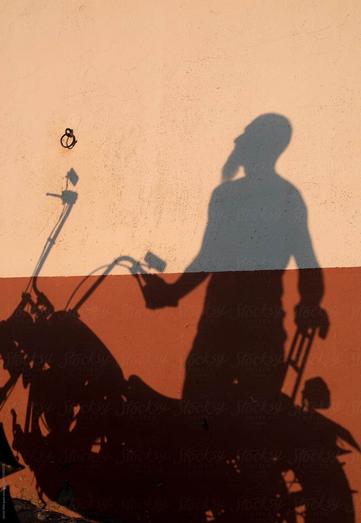 Shadow of a motorcyclist aged man