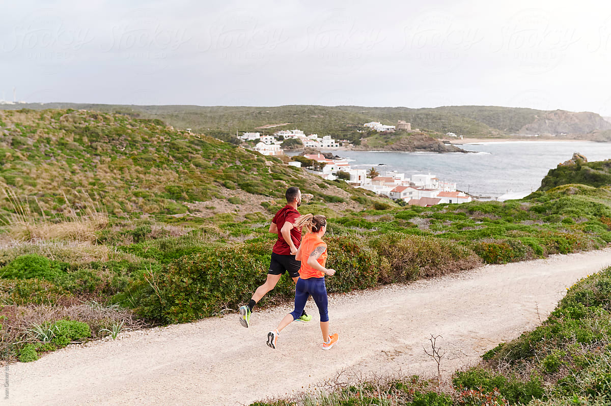 Fit couple running by the coast