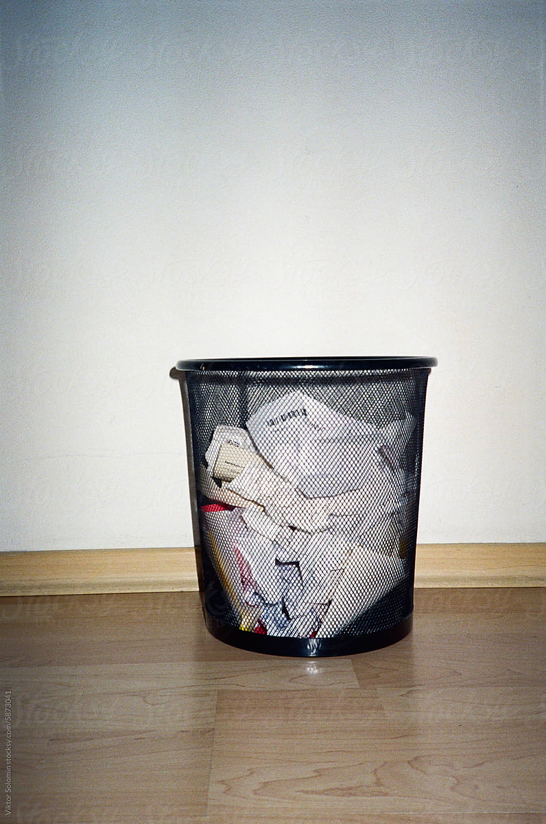 basket full of paper financial papers and receipts on floor in office
