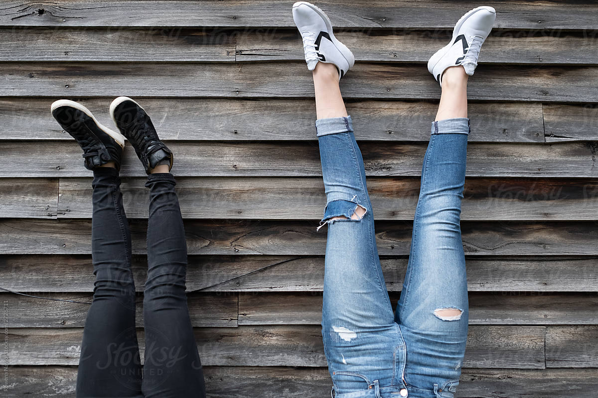 Handstand against a barn wall by two girls