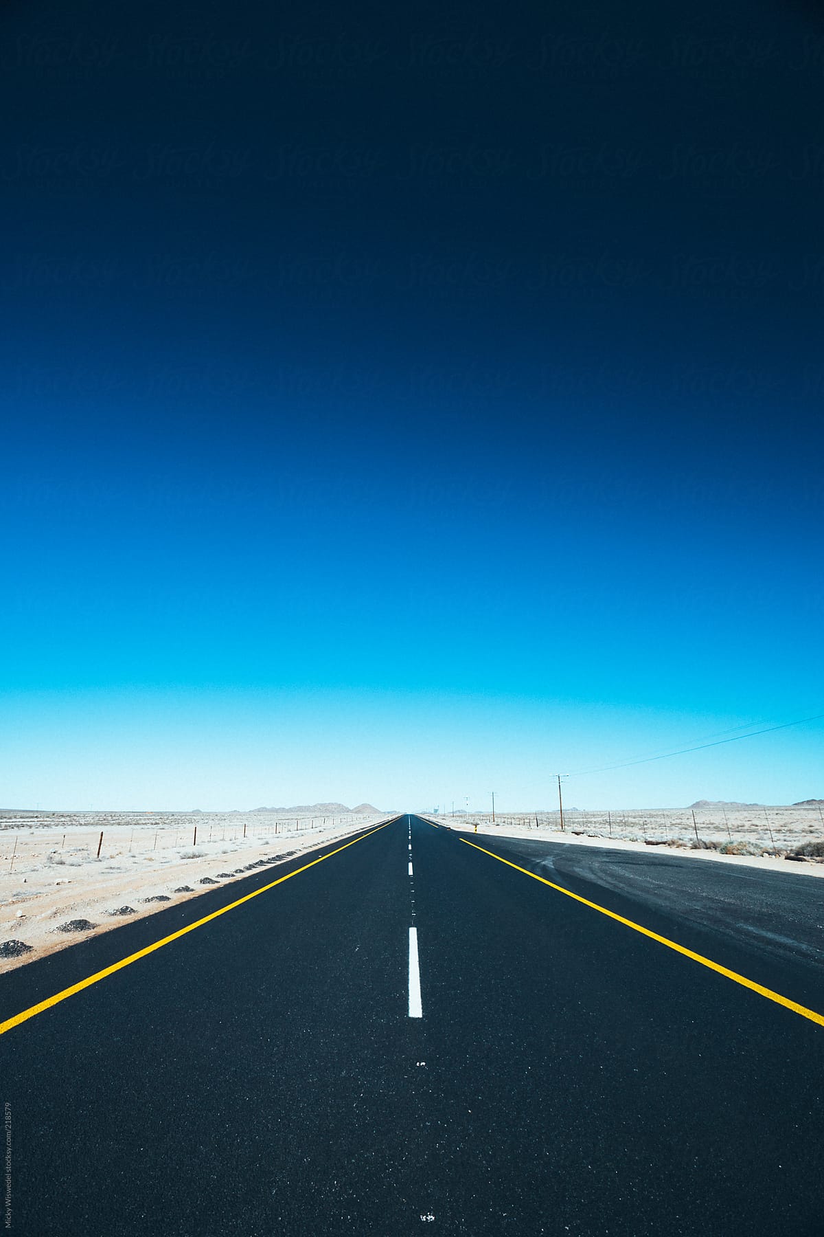 Long Open Road Through The Desert By Stocksy Contributor Juno Stocksy