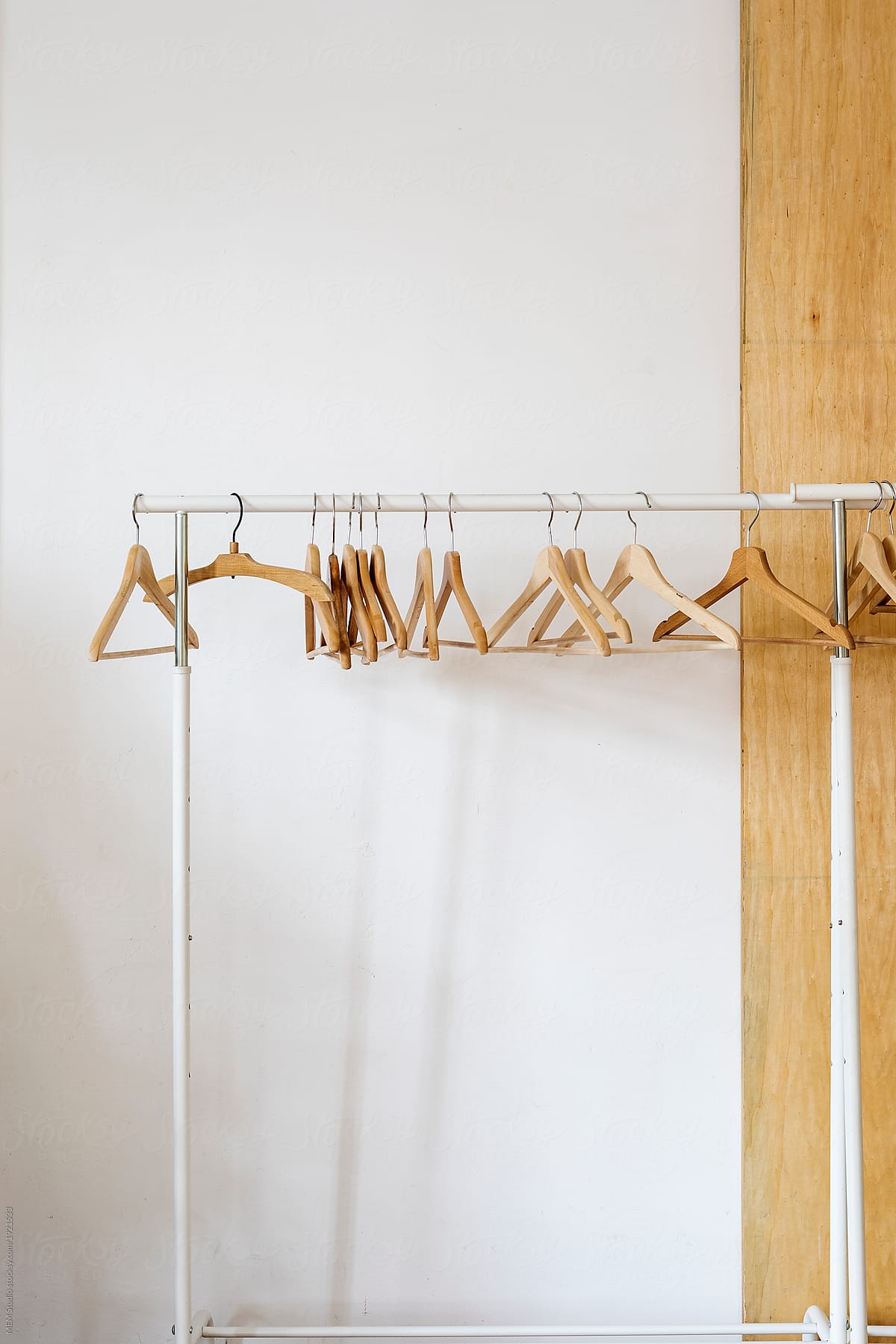 Empty wooden clothes hangers on a clothes rack