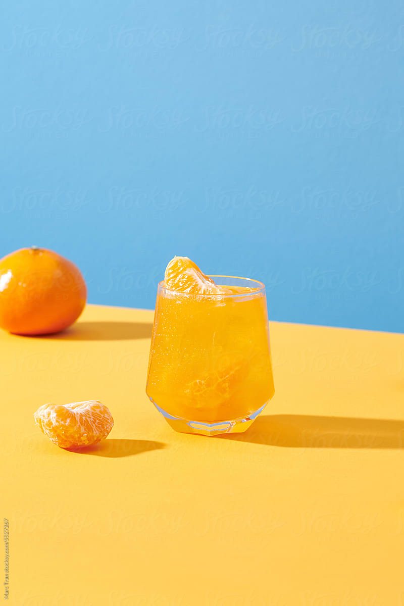 Creative layout made of fresh orange tangerine and a glass of juice