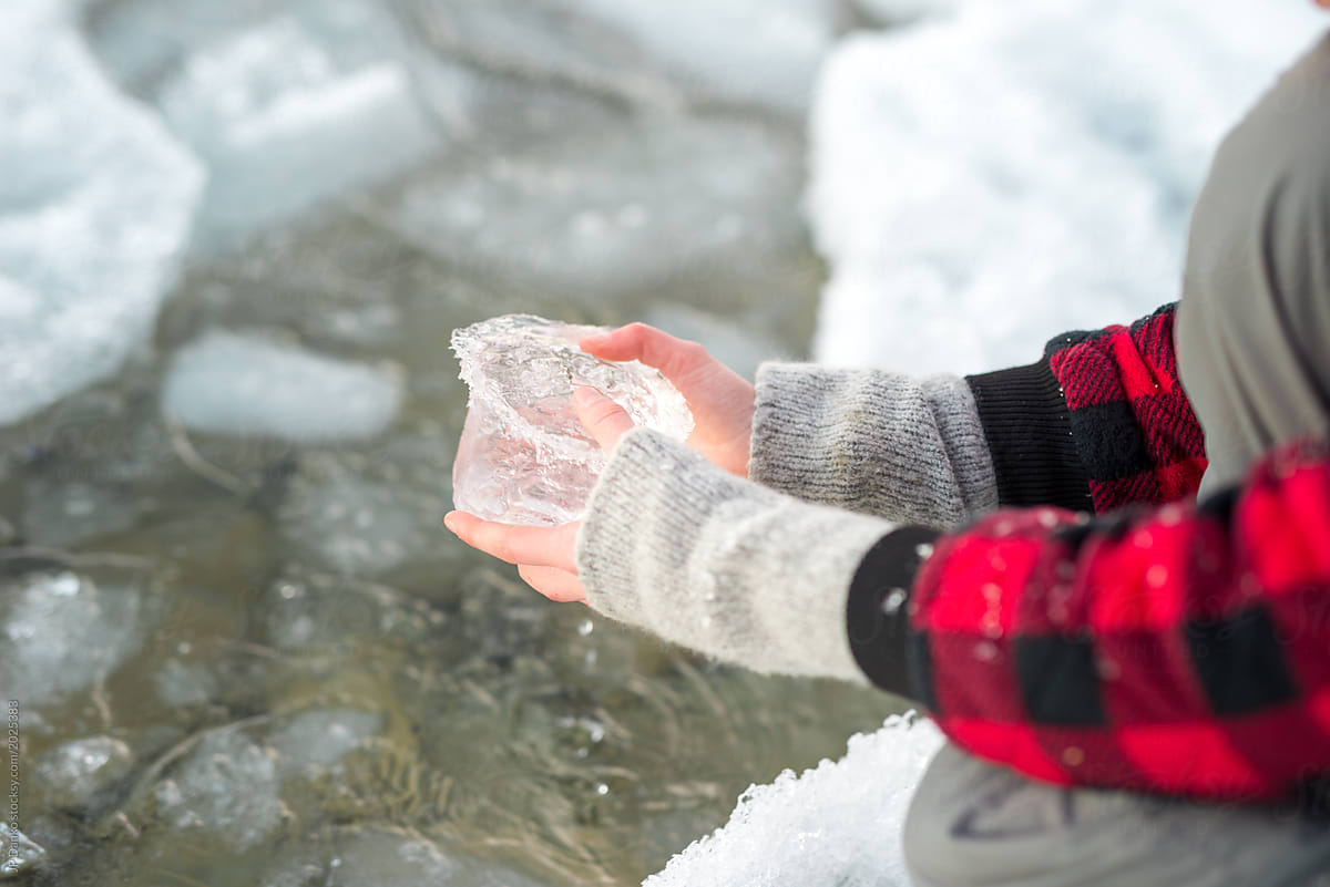 Girl holds piece of ice pulled from frozen Ontario lake