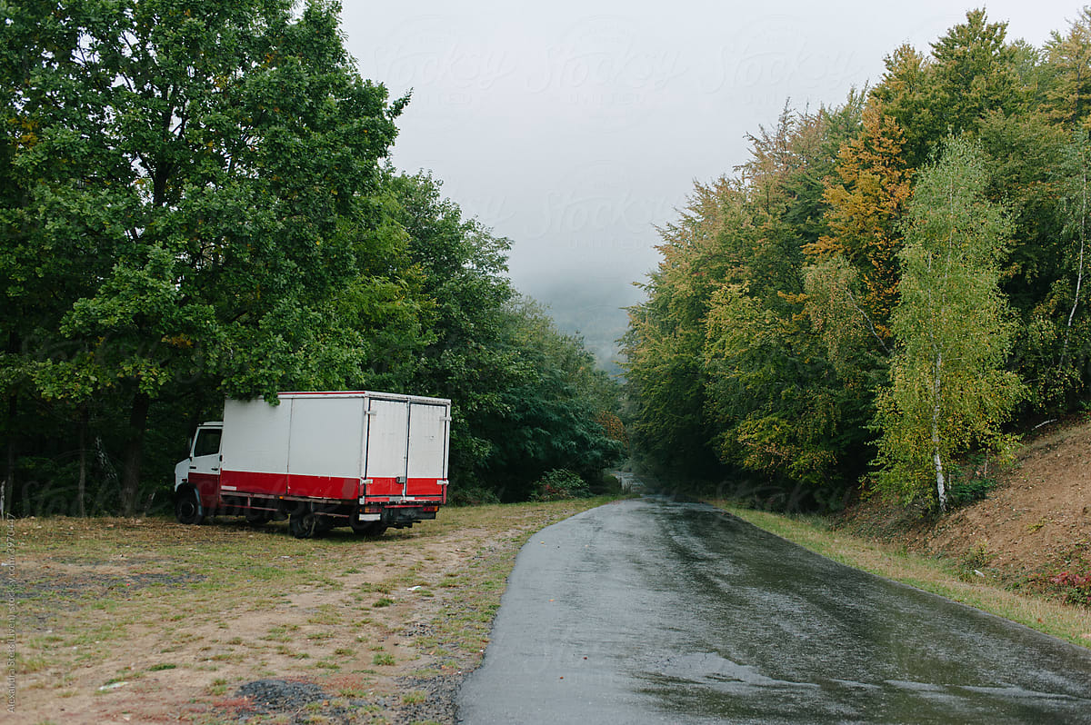 Red truck in the rainy mountain