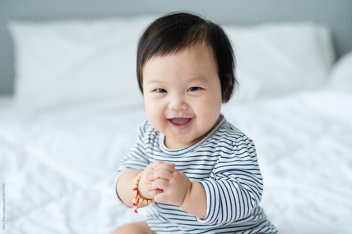 Happy and Funny baby smiling in bed