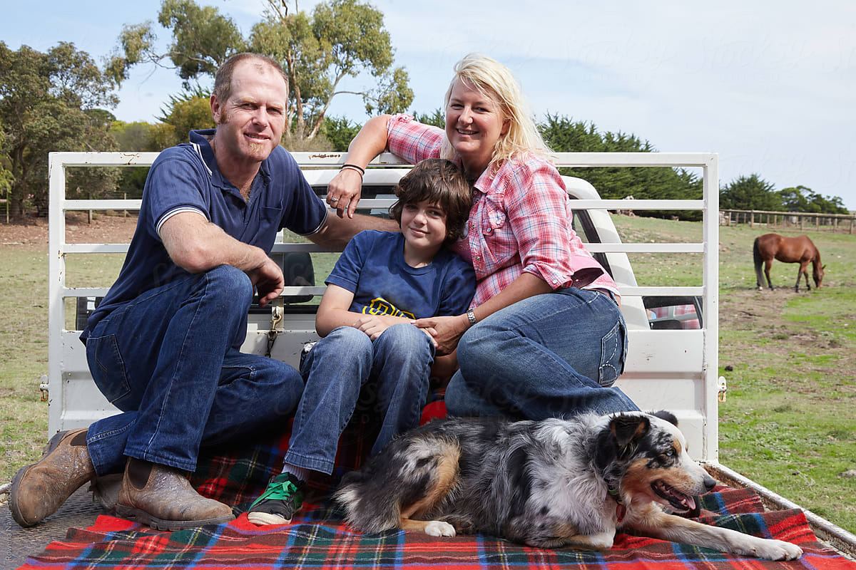 Casual portrait of farming family on back of ute