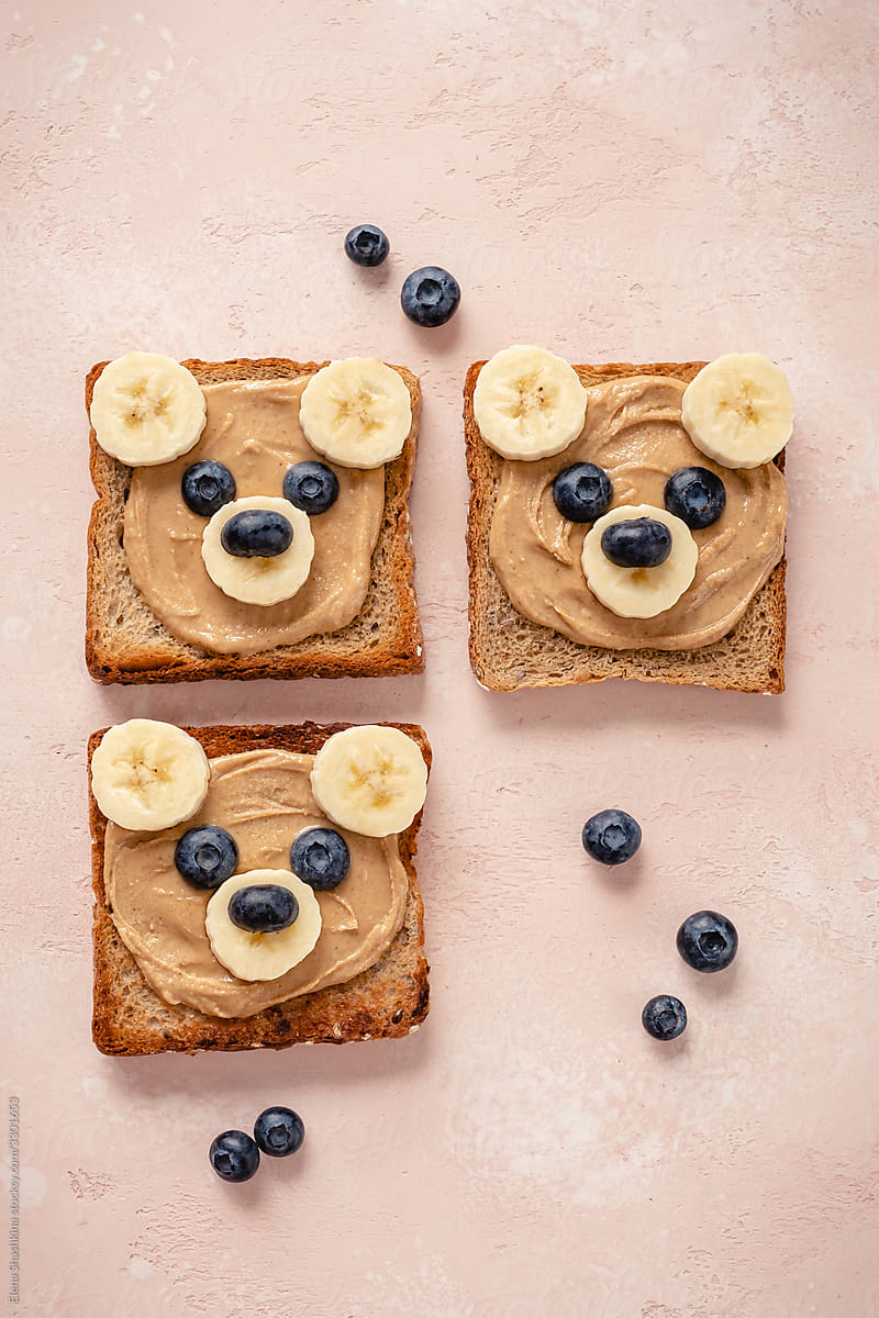 Cute bear face toasts with peanut butter, banana and blueberries
