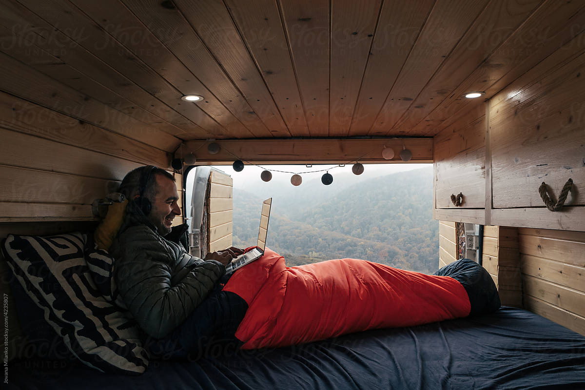 Man working on his laptop from tiny home