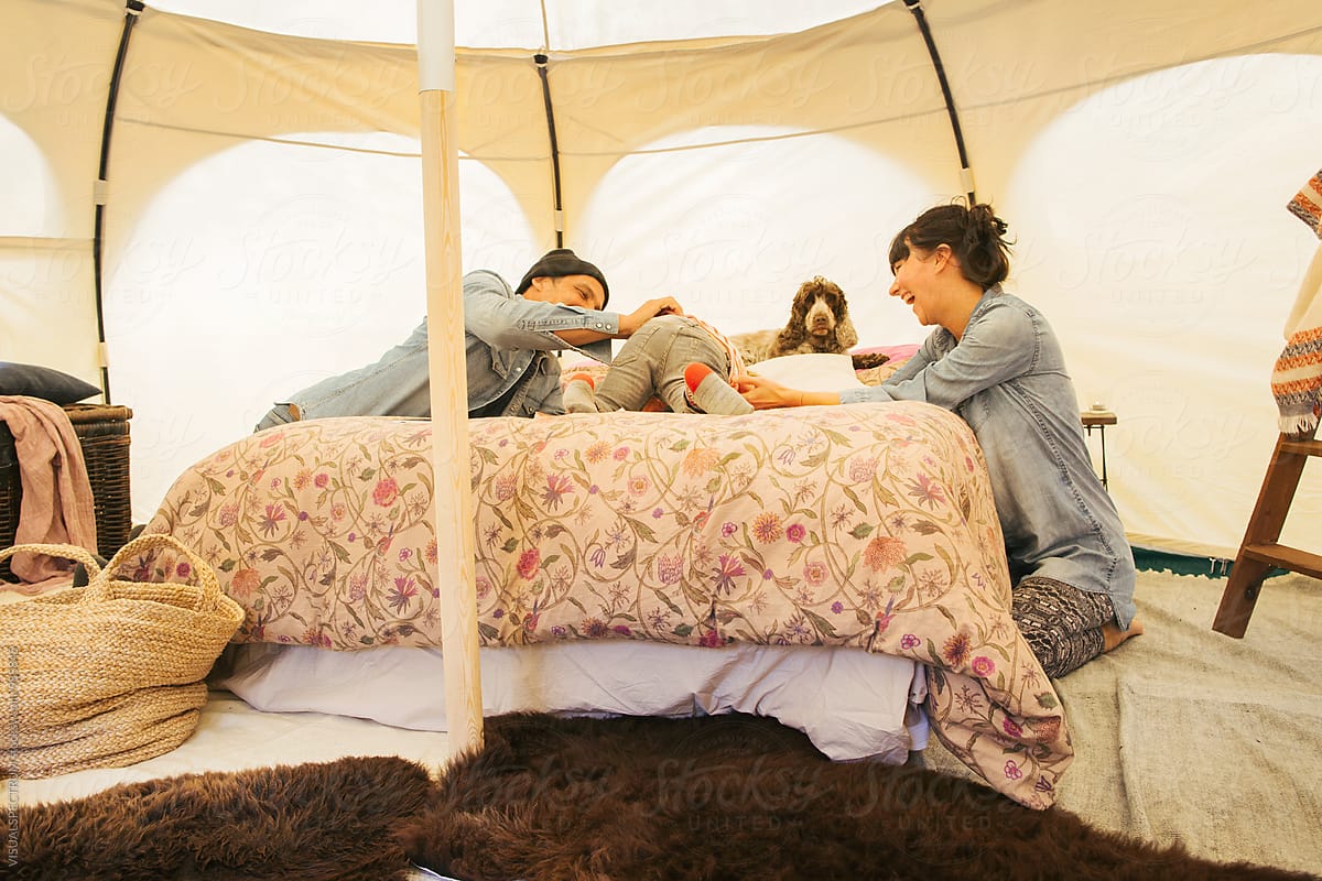 Glamping - Caucasian Family of Three Having Fun on Bed Inside Large Circular Tent