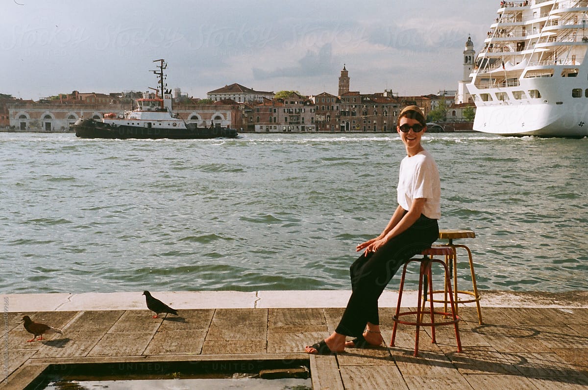 A beautiful woman sitting in Venice