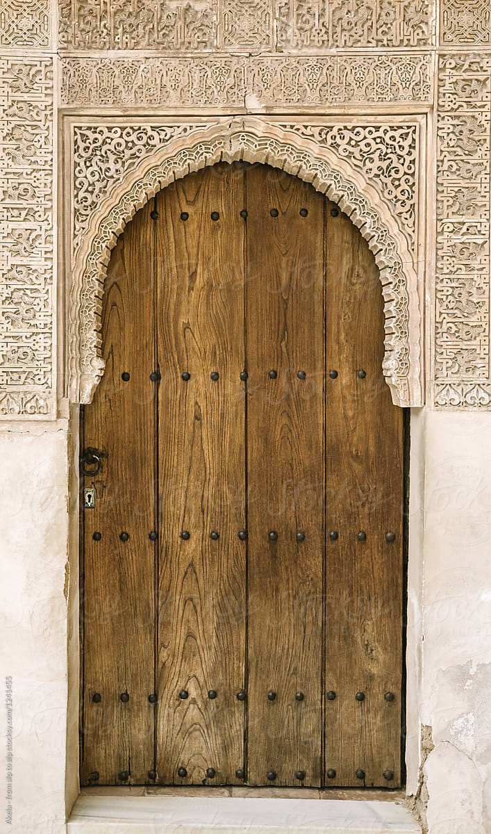 wooden door with arabic designed arch, alhambra, granada, spain