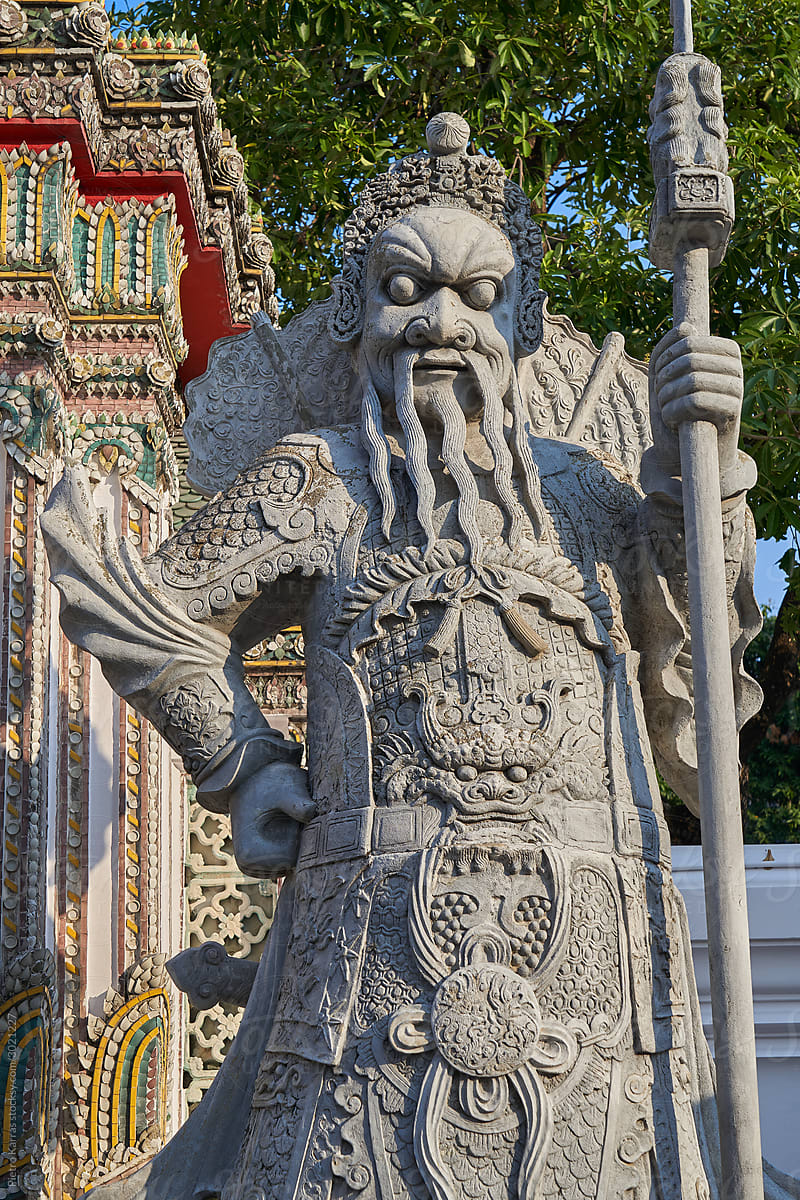 Old statue of oriental warrior in royal temple