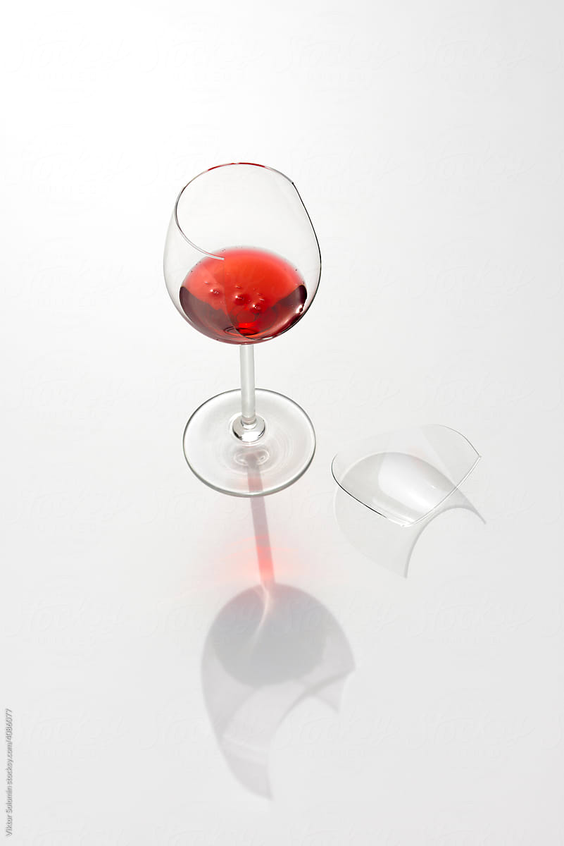 Broken glass with red wine