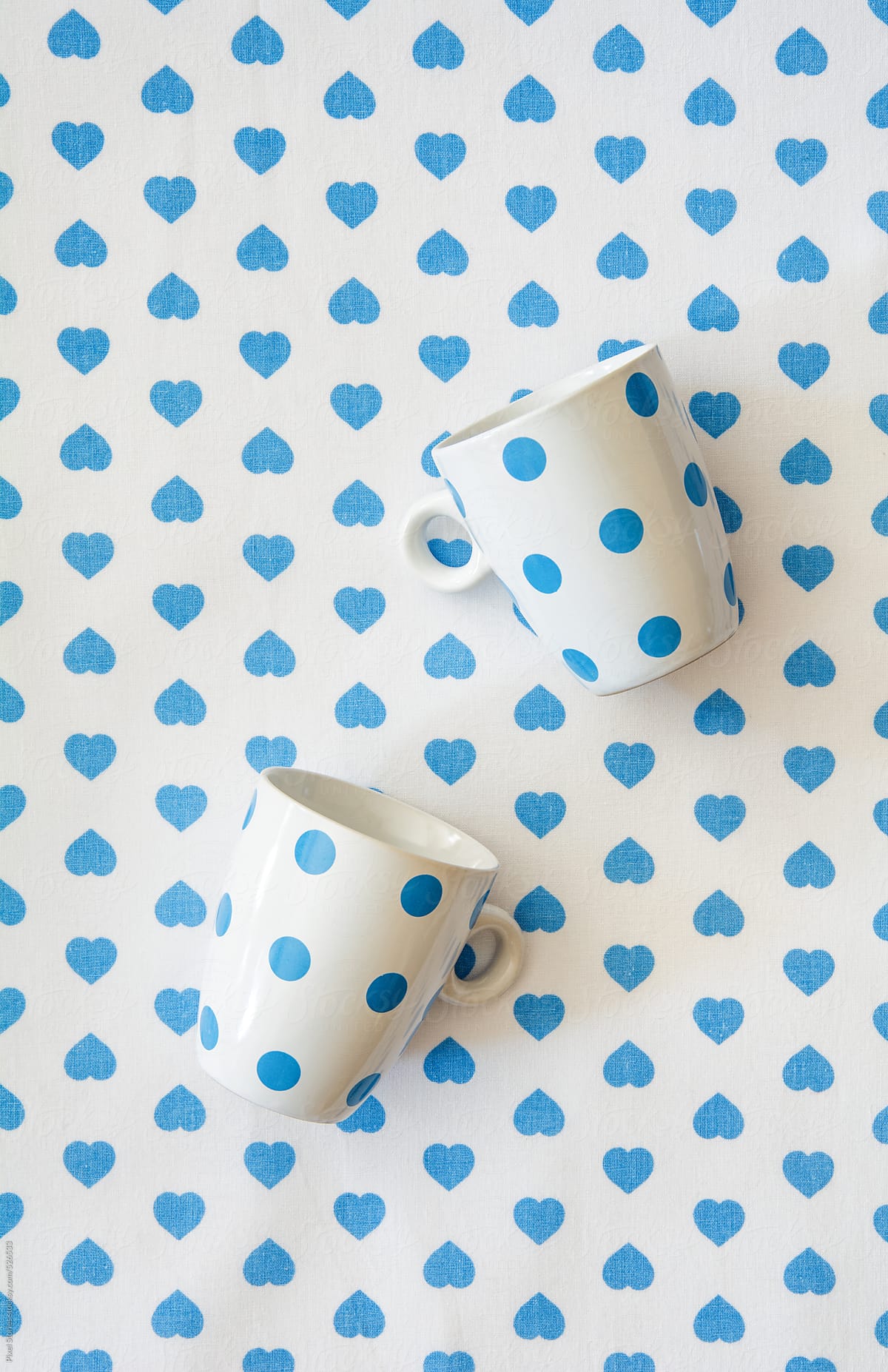 Blue-dotted cups on blue hearts cloth