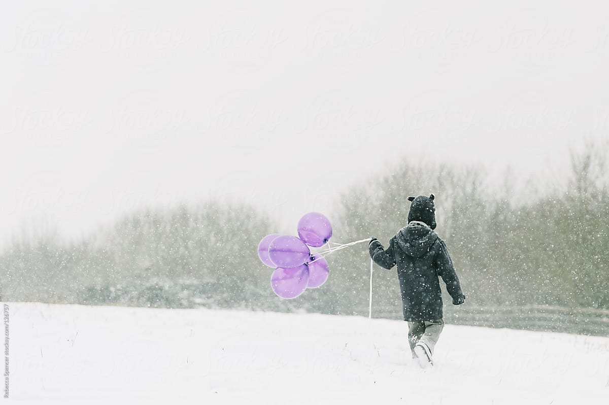 Child walking in falling snow