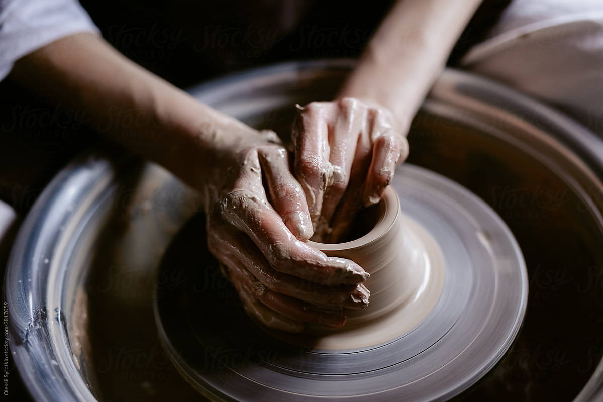 Hands of master at work with potter wheel