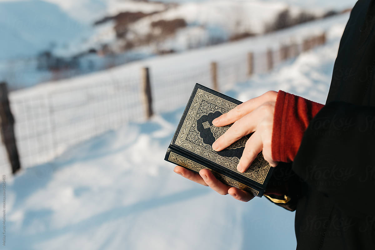 man holding Quran