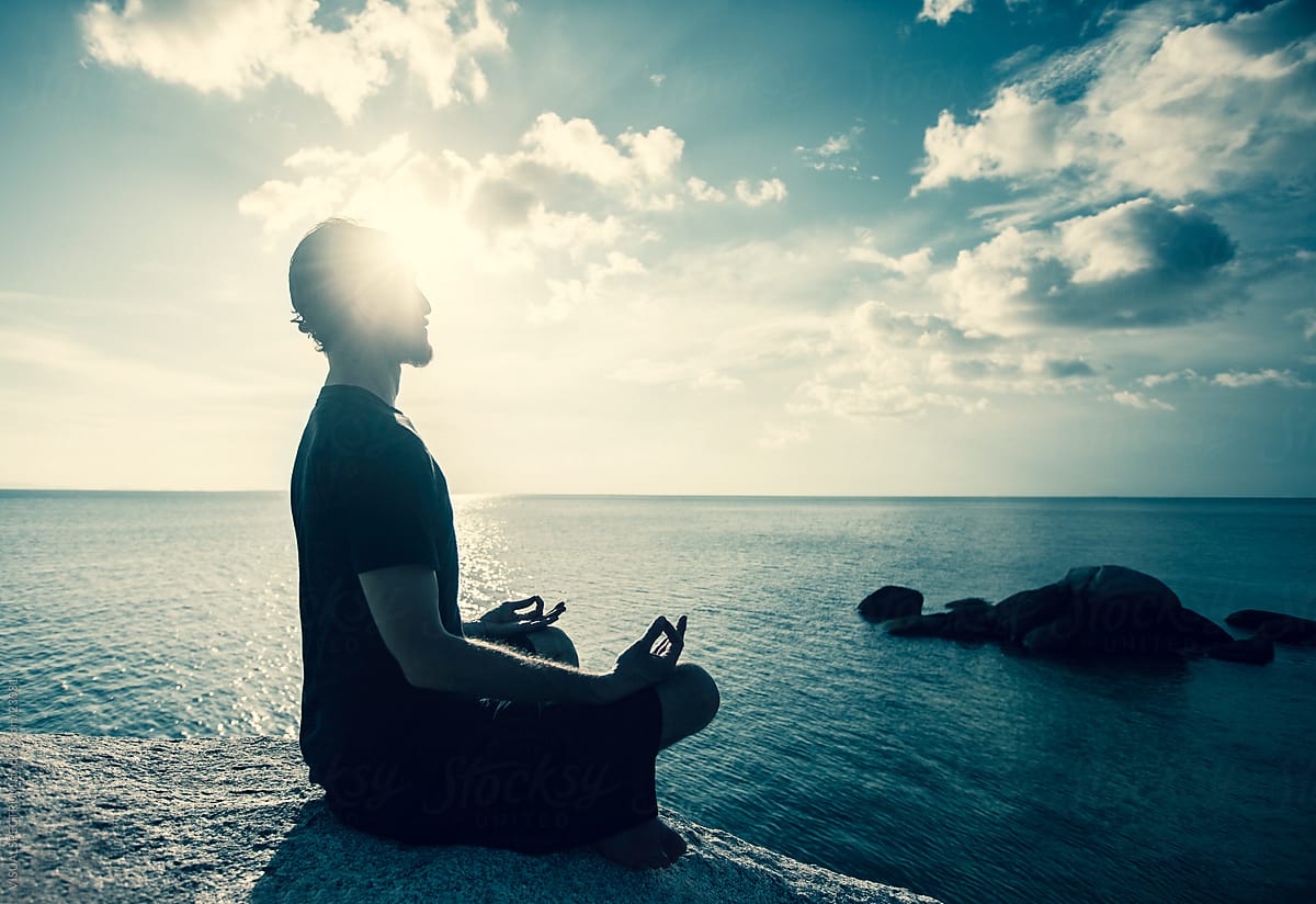 Man Meditating At Sunset by Stocksy Contributor VISUALSPECTRUM - Stocksy