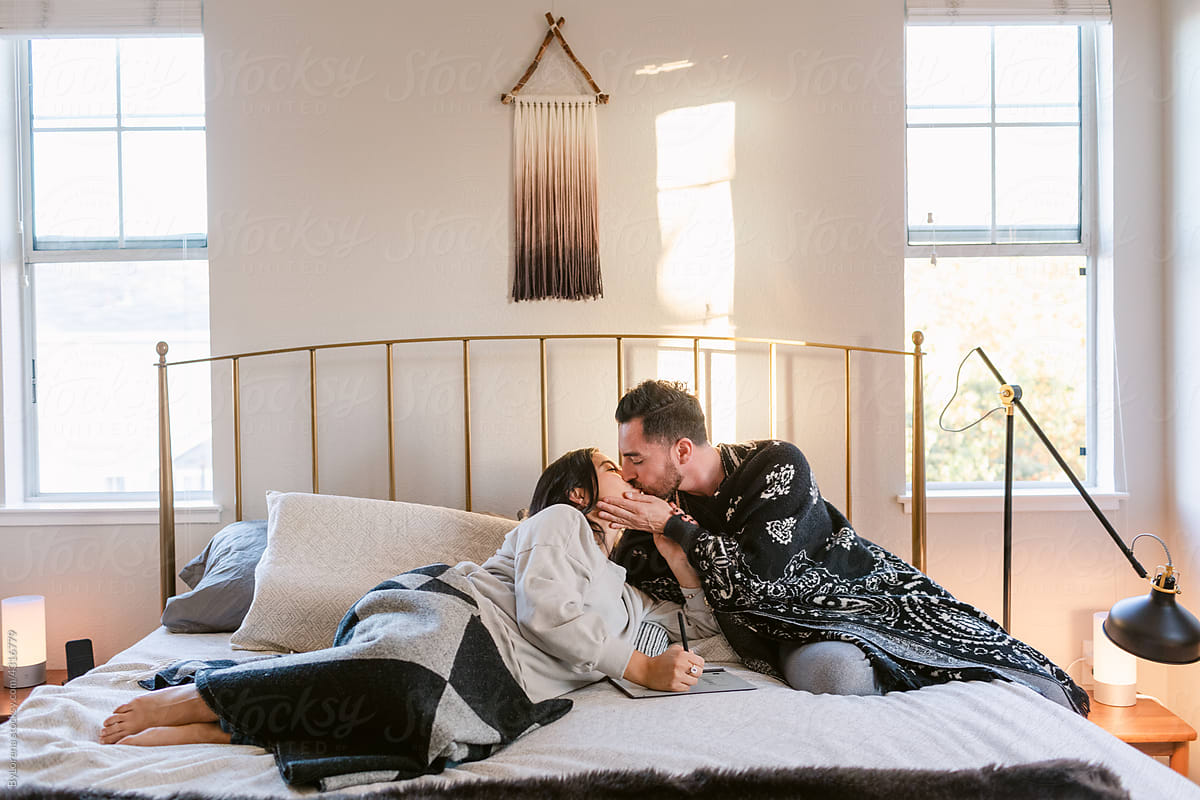 Young designer couple kissing in bedroom