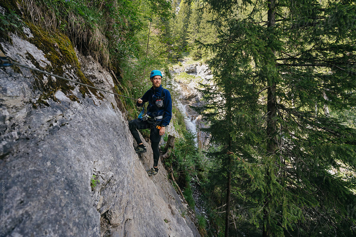 Man Climbing Via Ferrata Rock In Forest
