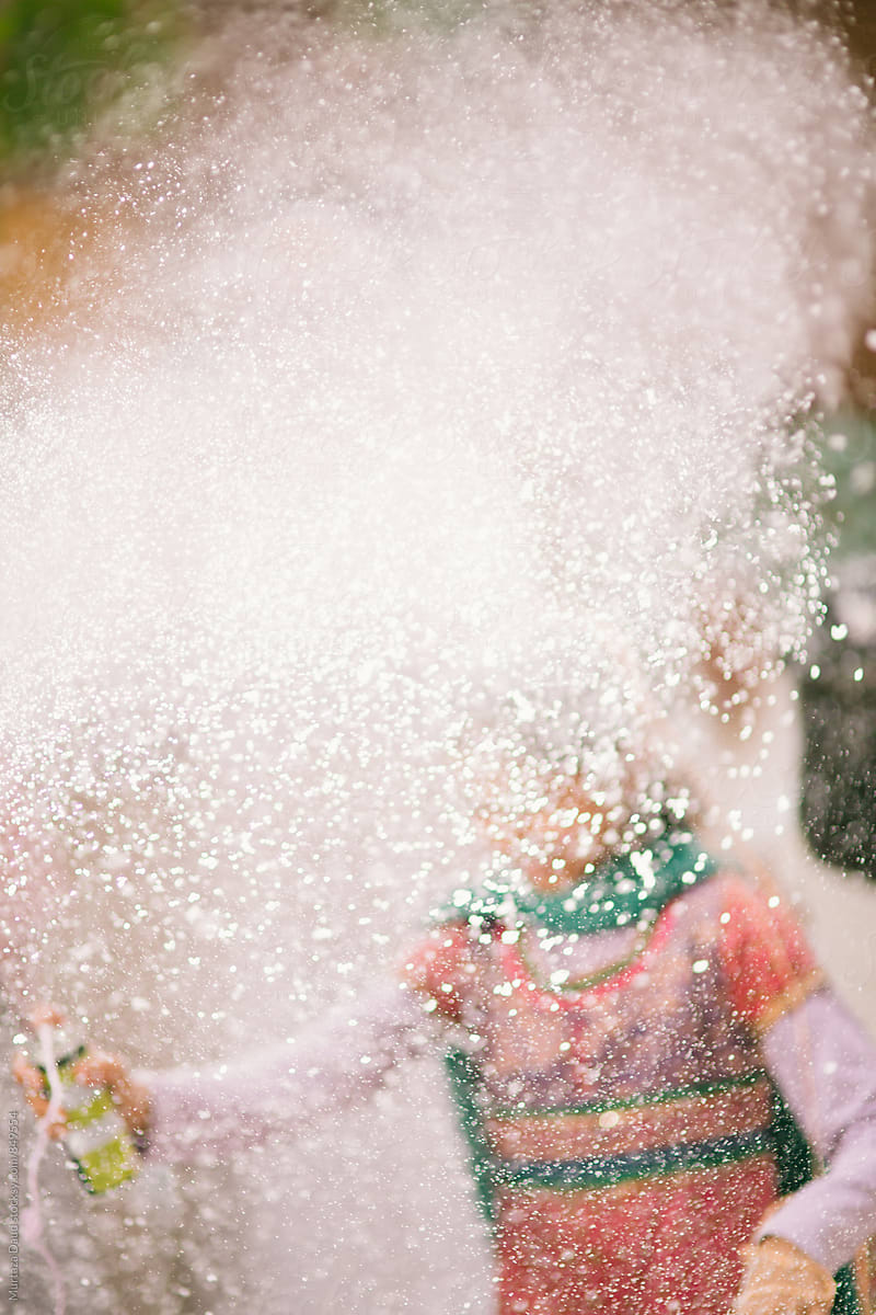 Young girl celebration with snow spray