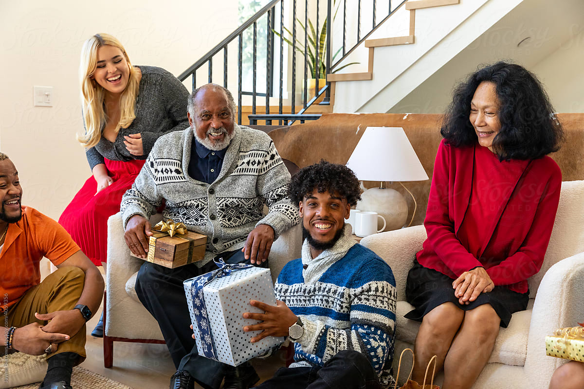 Family Smiles and Laughs during Holiday Gift Exchange