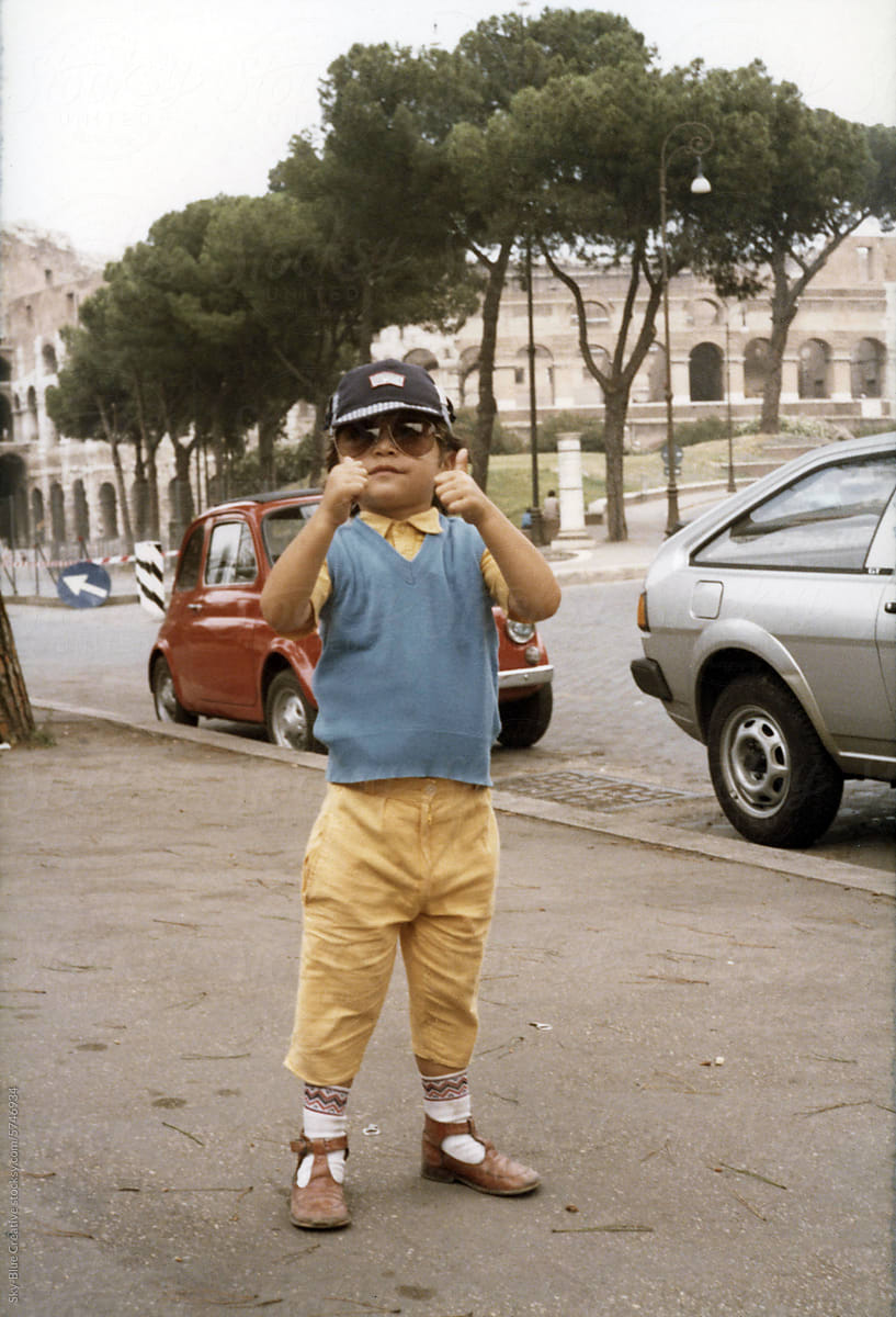 1983. A five-year-old with thumbs up poses for a photo on the street.