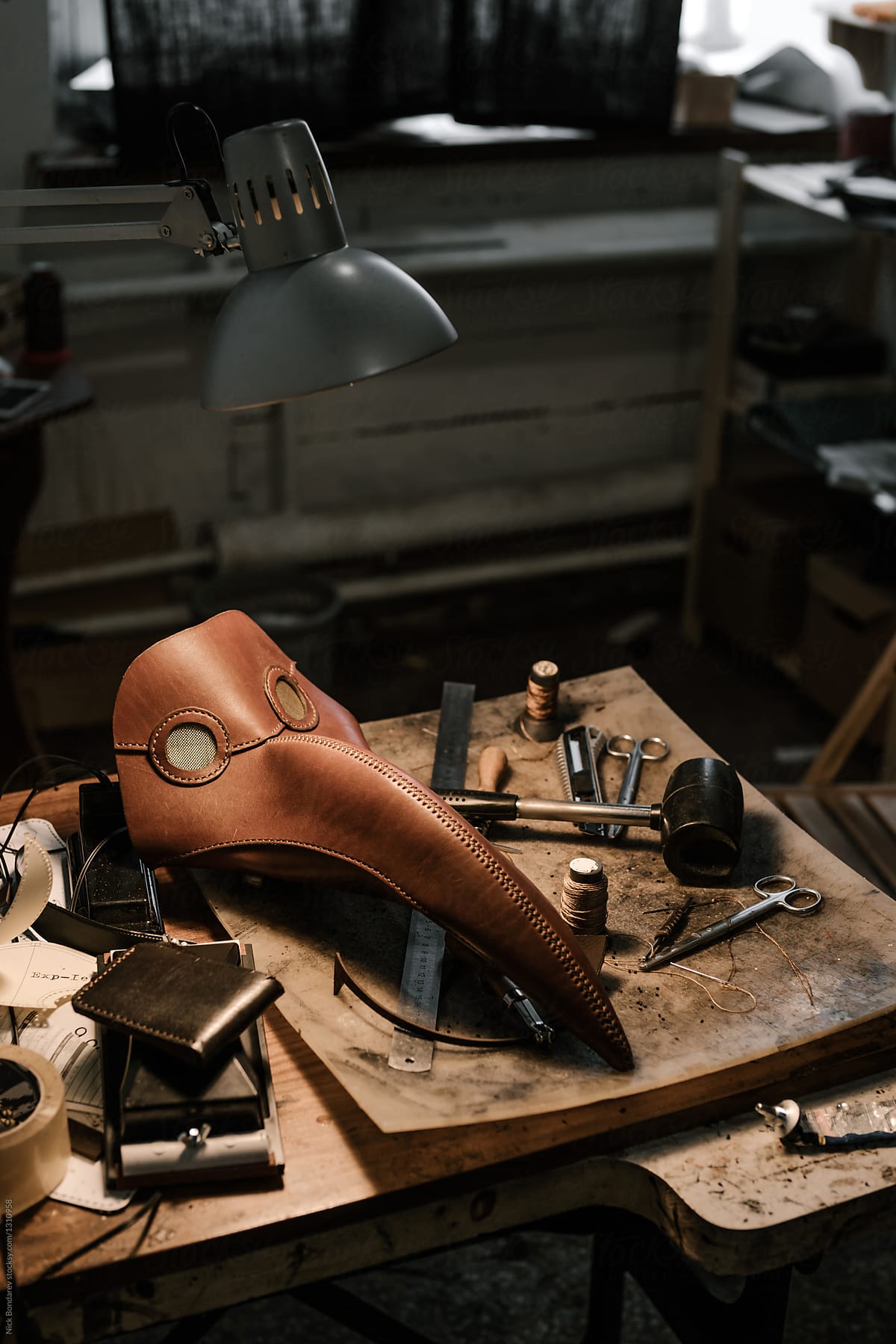 Close-up of Plague Doctor Mask and tools at manufacture of craft leather products