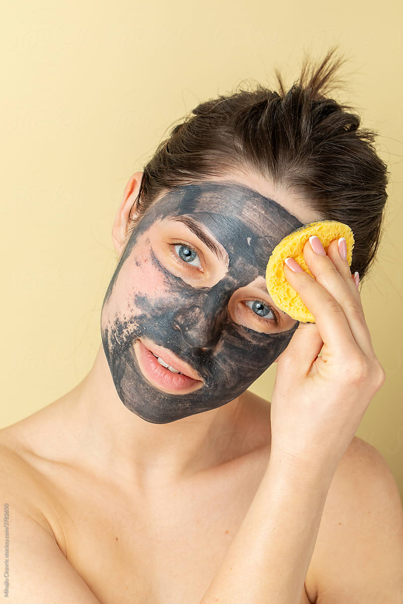 Woman Washing A Face Mask From Her Face