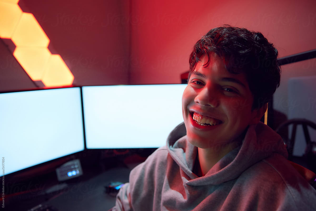 Young Smiling Man Playing Video Games Online