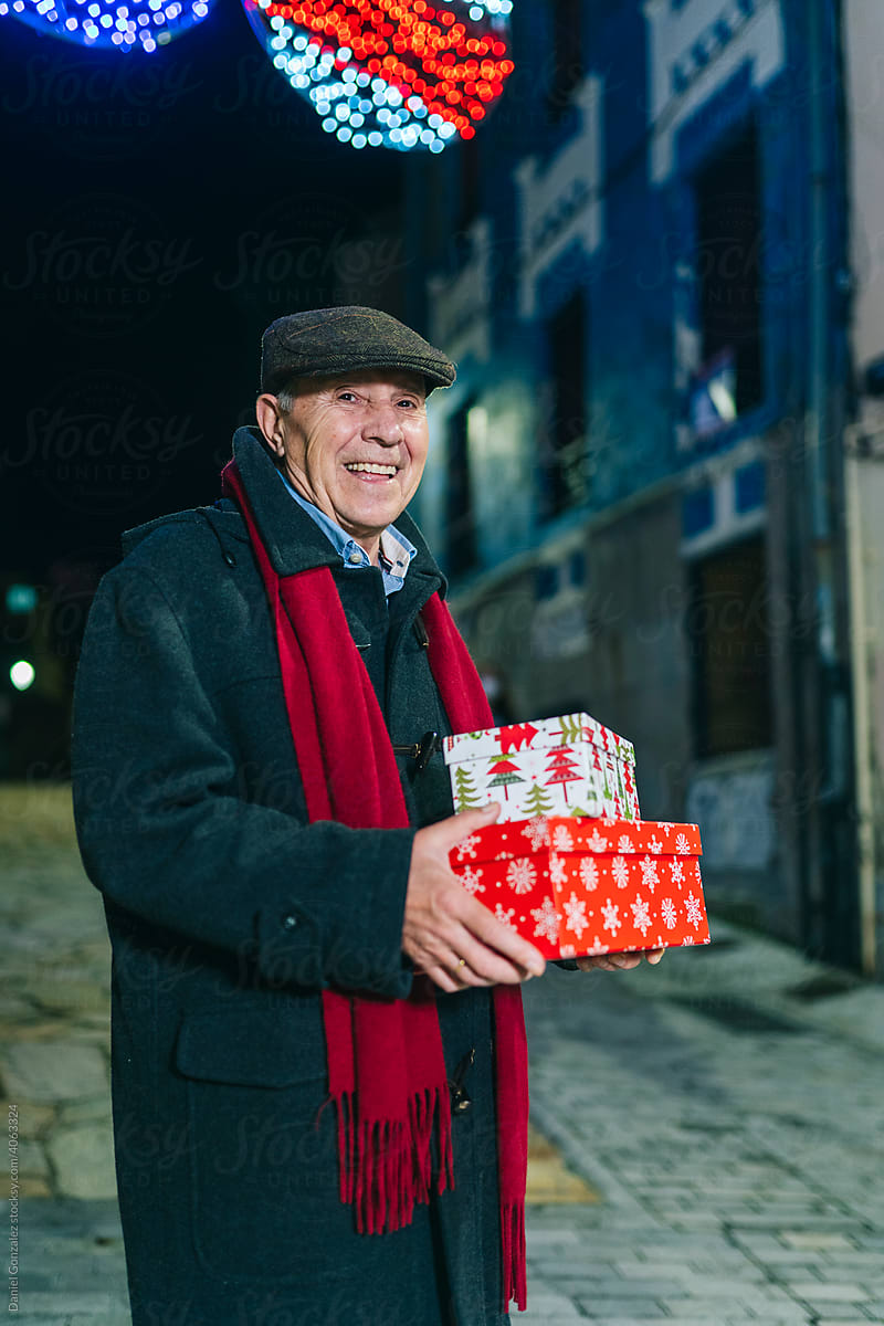 Elderly man with Christmas presents