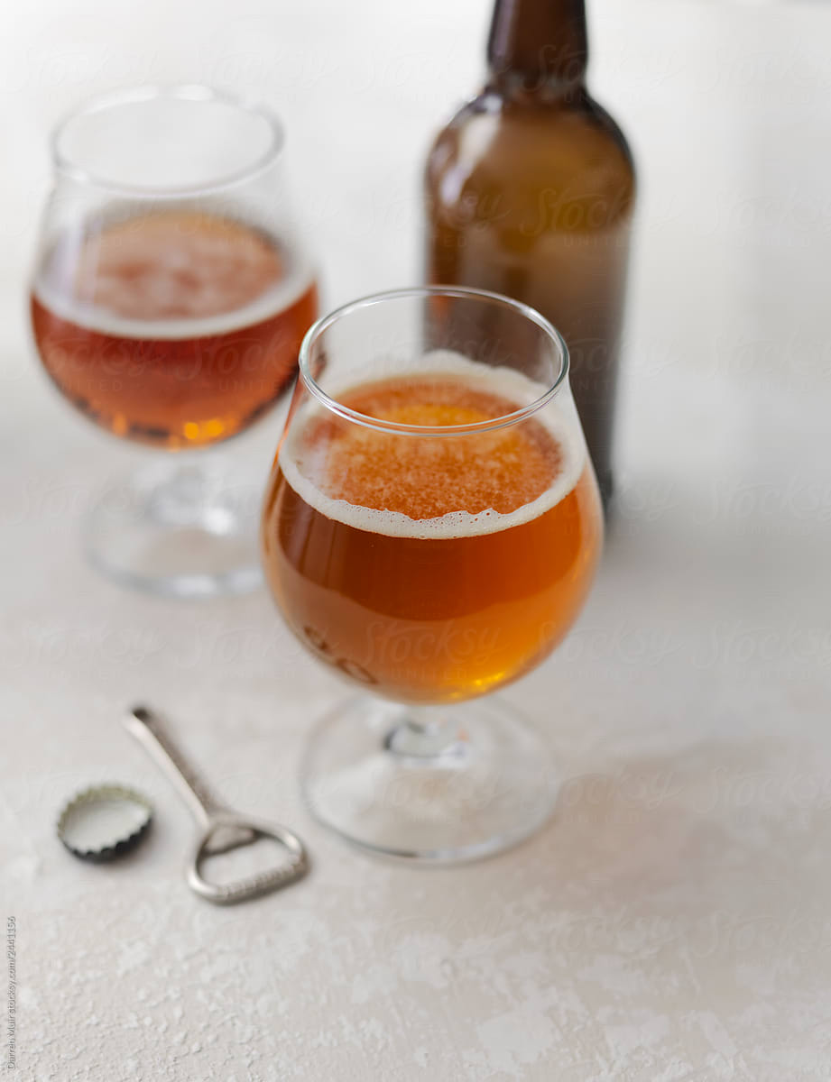 Stock photo of two glasses of pale ale on light background