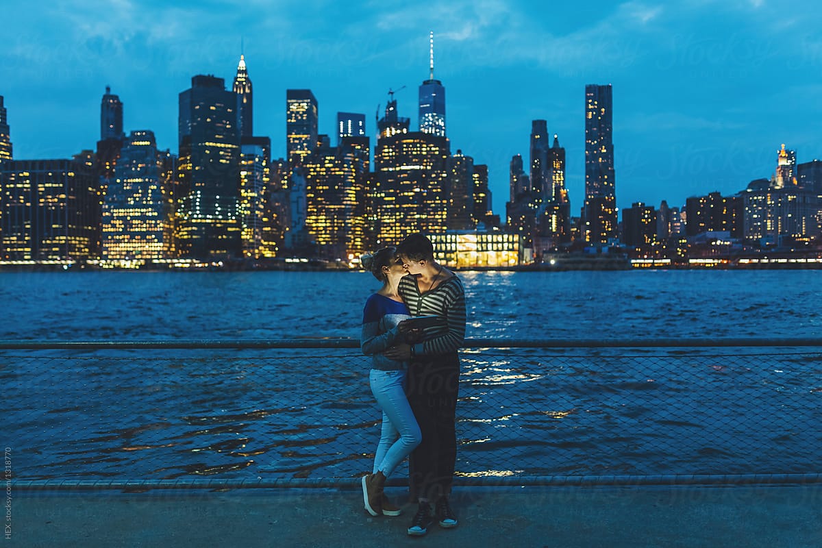 Young Couple Discovering New York City by Night With a Digital Tablet. US