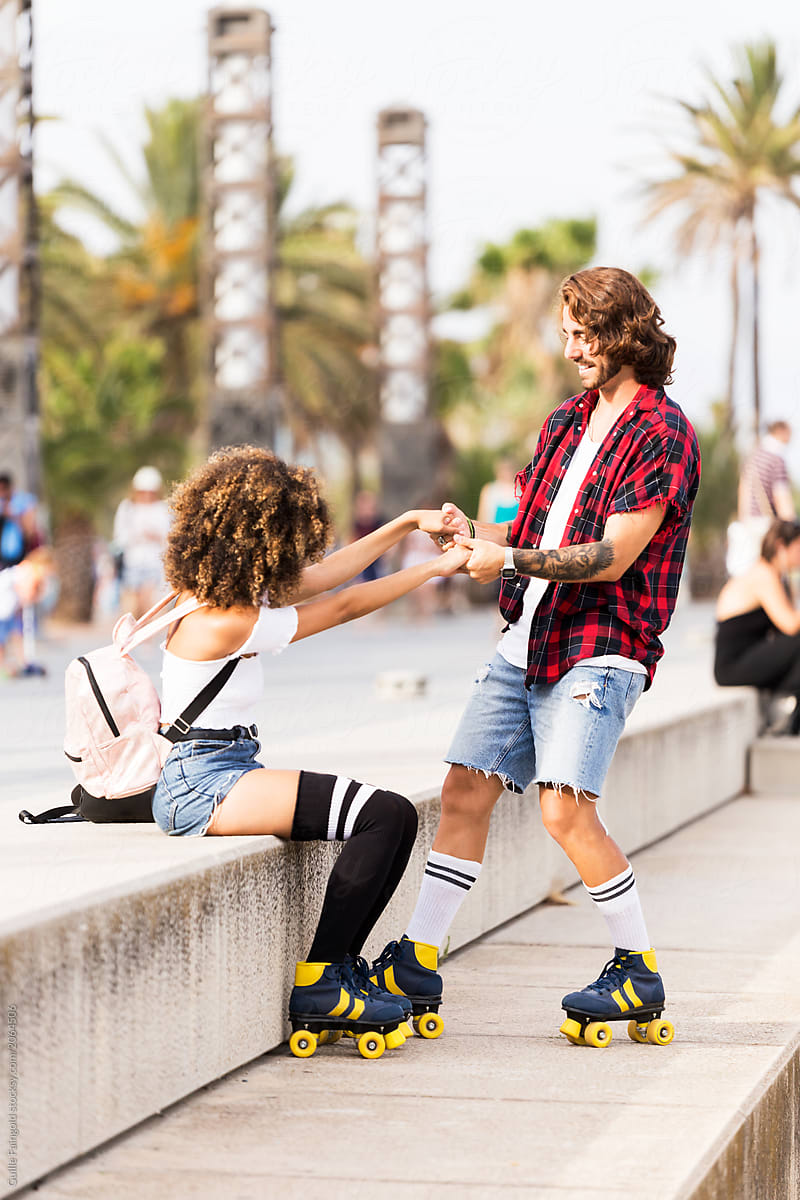 Couple on roller skates on street