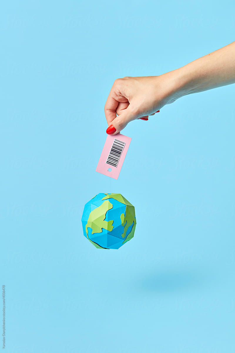 Woman holding papercraft Earth globe with barcode