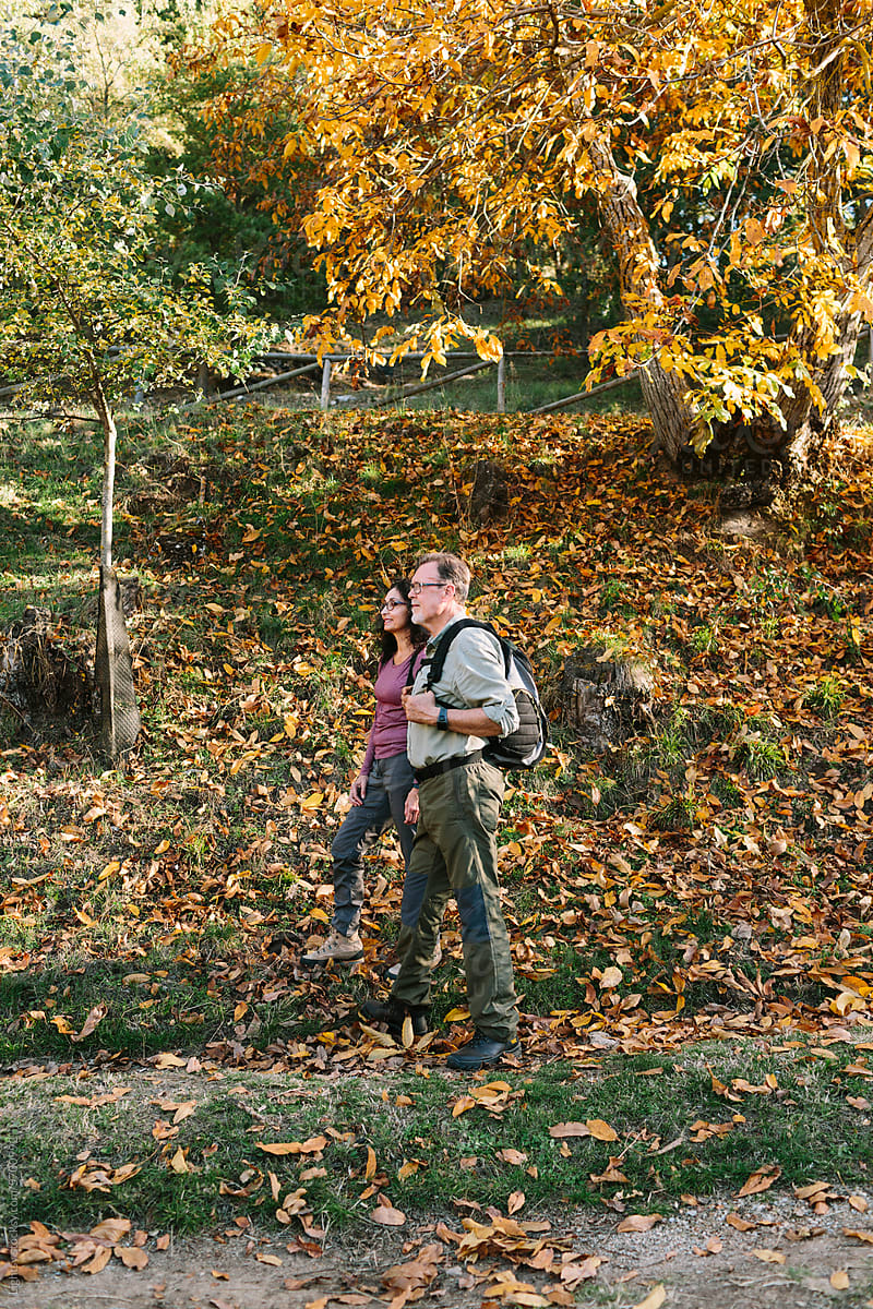 Senior couple hiking in the woods in Autumn