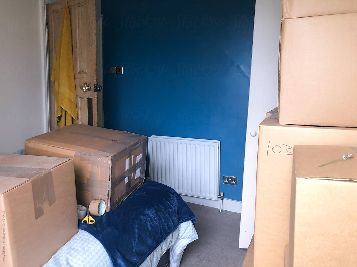 UGC moving house piles of boxes in bedroom