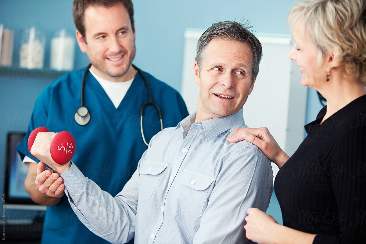 Exam Room: Cheerful Mature Man Does Physical Therapy