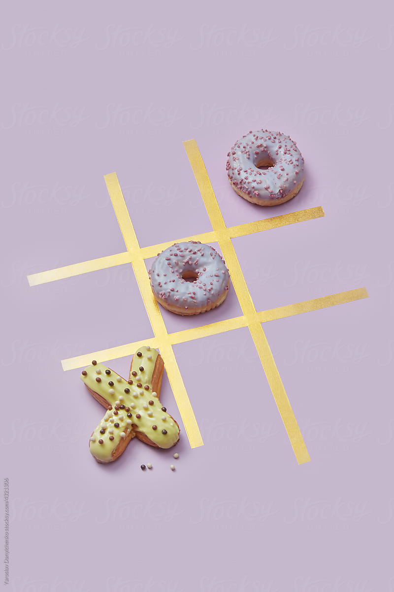 Glazed donuts and eclairs in tic-tac-toe game